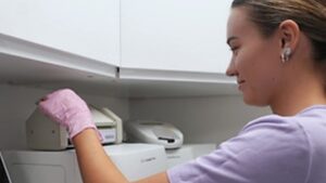 A veterinary nurse at Elizavet using some diagnostics equipment.